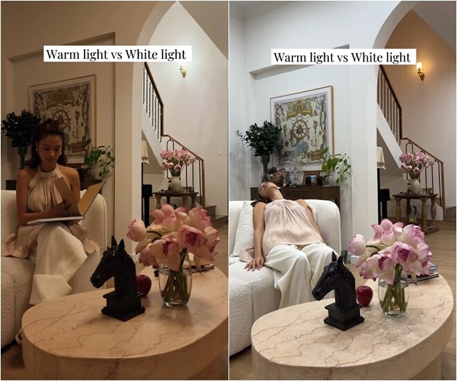 Khu vực phòng khách được thiết kế tinh tế với sofa cong bọc vải boucle trắng kem và bàn trà đá cẩm thạch sang trọng. Nàng hậu khéo léo trải nghiệm sự thay đổi cảm xúc của không gian giữa ánh sáng trắng hiện đại (White light) và ánh sáng vàng ấm cúng (Warm light) khi thư giãn đọc sách tại nhà.