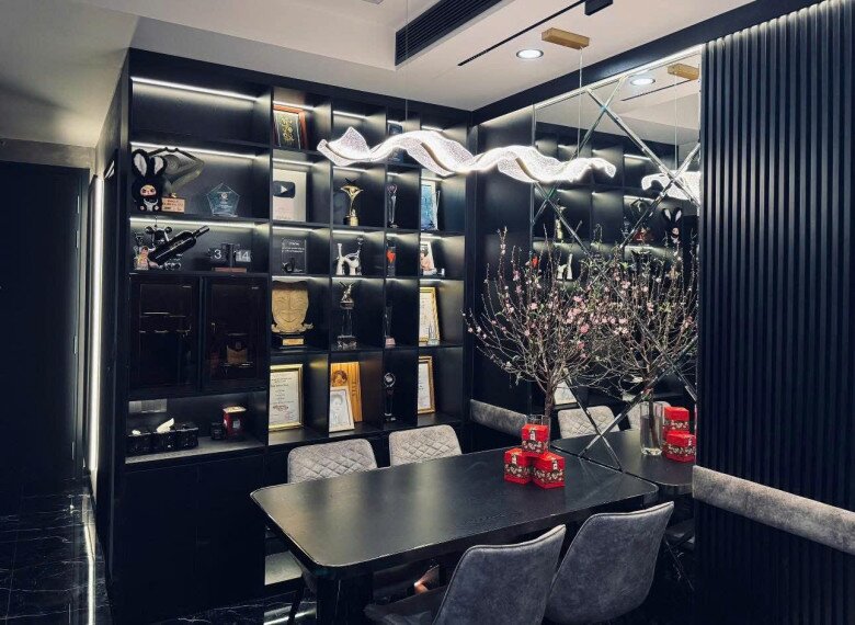 Góc trưng bày cúp và kỷ niệm chương đầy tự hào trong căn hộ của anh tại TP.HCM. Việc khéo léo kết hợp hệ tủ tối màu cùng dải đèn led rực rỡ tạo nên điểm nhấn cực kỳ sang trọng cho khu vực phòng ăn.