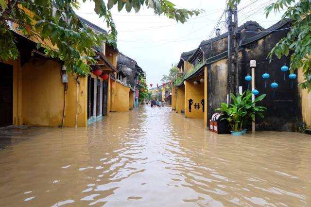 Phố cổ Hội An chìm trong nước lũ, người dân và du khách chèo xuồng để di chuyển - 10