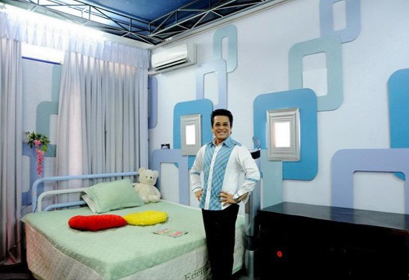 Phòng ngủ tầng hai cũng mang sắc xanh chủ đạo với những hoa văn vuông tròn độc đáo trên mảng tường.
