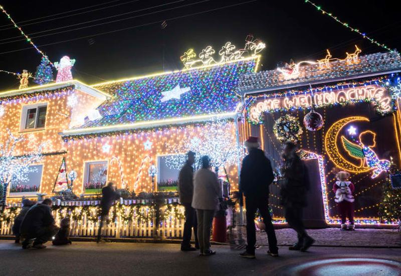 Khách du lịch dừng chân ngắm nhìn một ngôi nhà được trang hoàng bằng đèn và phụ kiện Giáng sinh tại thị trấn Walschleben, nước Đức. Chủ sở hữu ngôi nhà này nói rằng anh đã trang trí bằng hơn 13.000 chiếc đèn bao quanh nhà từ tháng 10 để kịp mùa Noel năm nay.
