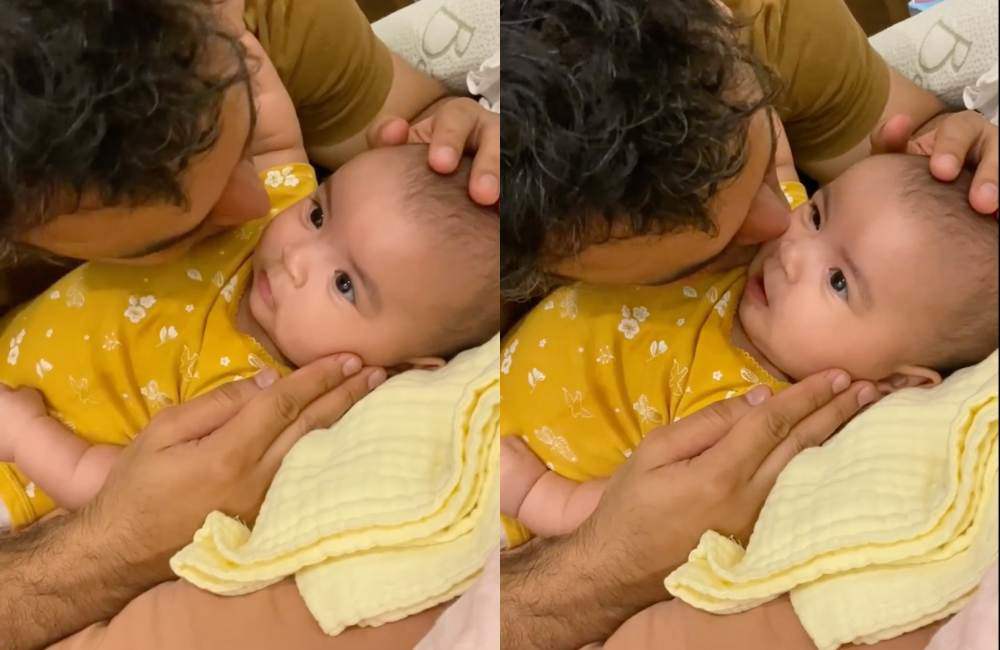 Biểu cảm đáng yêu của con gái Võ Hạ Trâm khi được bố ôm hôn.