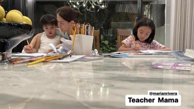 Marian diện đồ ngủ, không trang điểm ở nhà chăm các con và dạy bọn trẻ học hành.