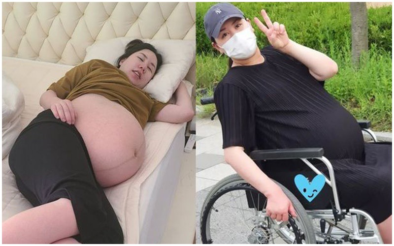 Cơ thể nặng nề với chiếc bụng bầu to quá khổ khiến mỹ nhân xứ Hàn phải dùng xe lăn di chuyển ở những tháng cuối.
