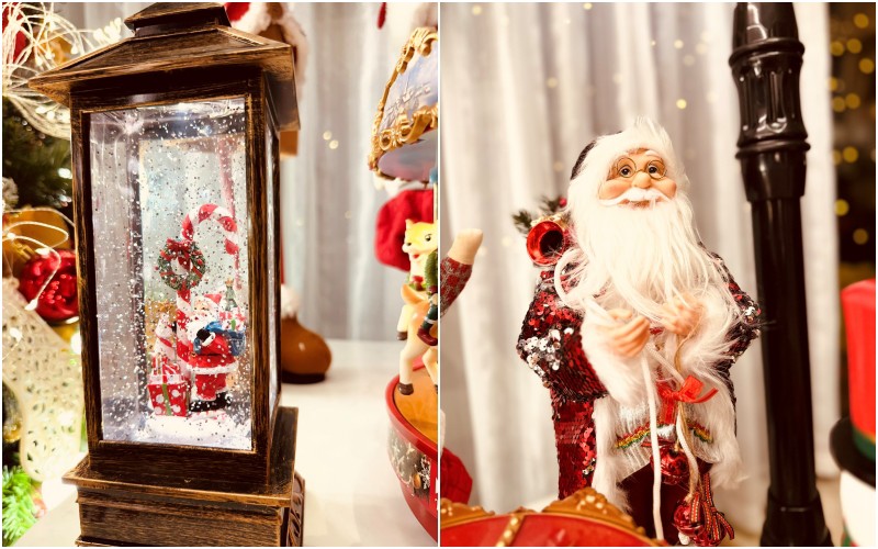 Mô hình ông già Noel vác quà đi phát và đèn Giáng sinh lấp lánh tuyết rơi. 
