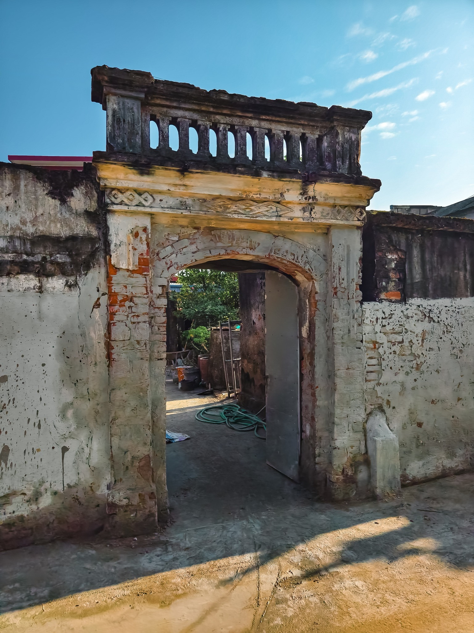 South Gate of the village (left) and a house gate (right)