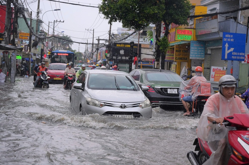 Mưa lớn, người dân TP.HCM vất vả vượt đường ngập - 7