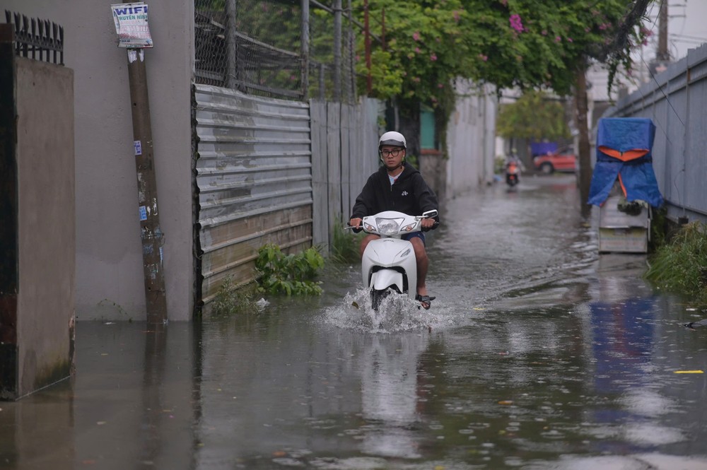 Mưa lớn, người dân TP.HCM vất vả vượt đường ngập - 11