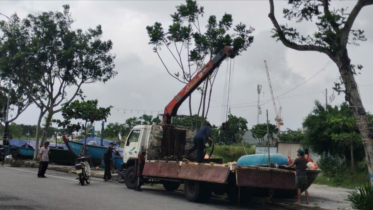 Dịch vụ xe tải cẩu tàu thuyền lên bờ hoạt động từ sáng sớm. Ngư dân đặt lịch cẩu tàu, thuyền thúng rất nhiều, nên đội hình lái xe tải cẩu phải tranh thủ dậy sớm, kêu thêm người hỗ trợ để làm việc.