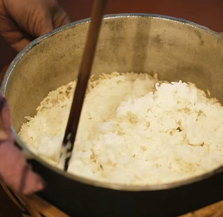 Cơm được nấu bằng nồi gang trên bếp củi, lớp cháy vàng giòn dưới đáy. Cặp đôi đã làm hương vị tuổi thơ được tái hiện đầy cảm xúc.