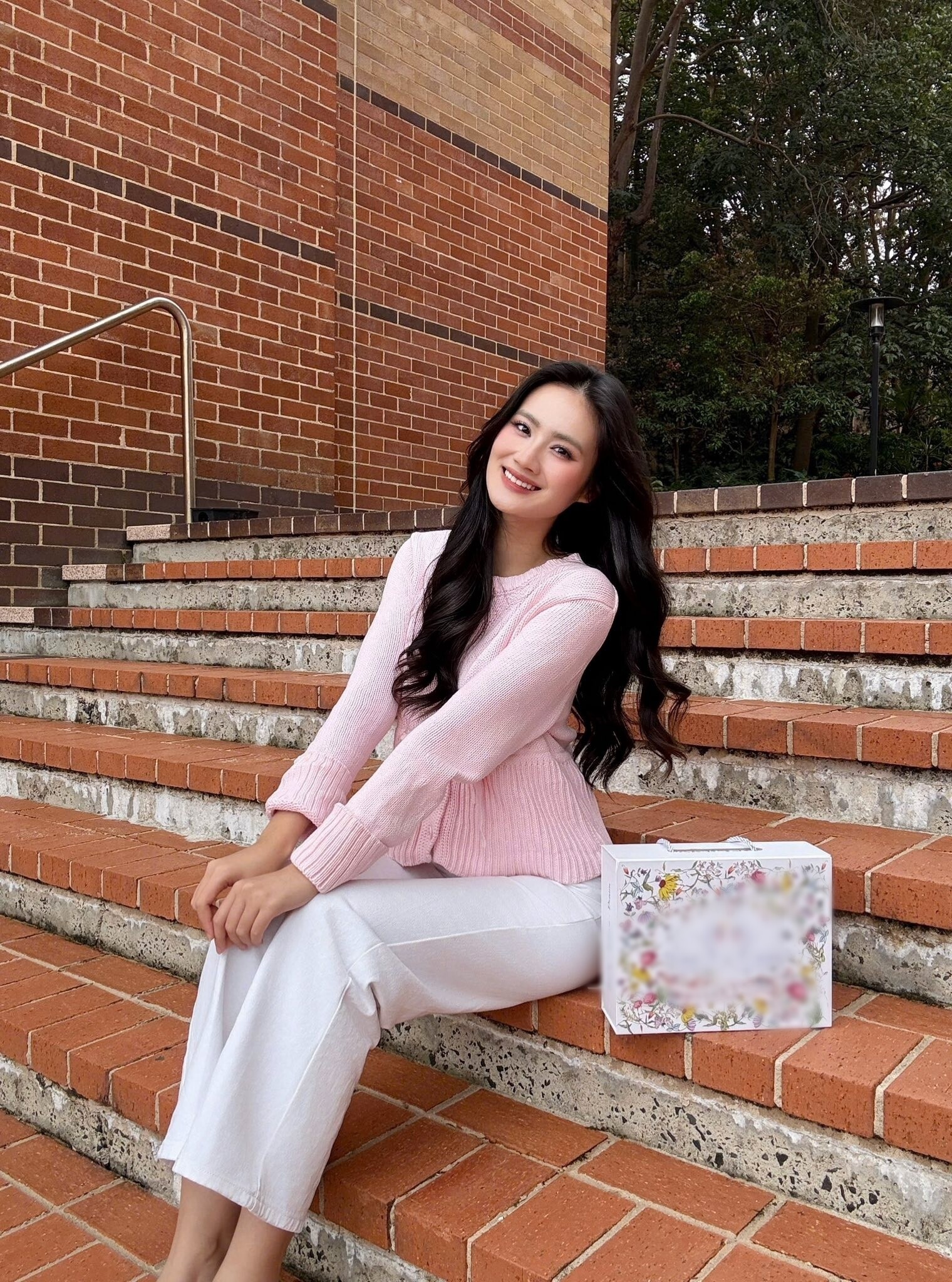 Lựa chọn áo len hồng nhạt chiết eo nhẹ phối cùng quần sáng màu - outfit đơn giản nhưng tạo hiệu ứng rất tươi tắn cho hoa hậu Ý Nhi. Tông pastel là “vũ khí” giúp gương mặt trông rạng rỡ, hợp với những ai thích sự nhẹ nhàng và duyên dáng nhưng không quá cầu kỳ.