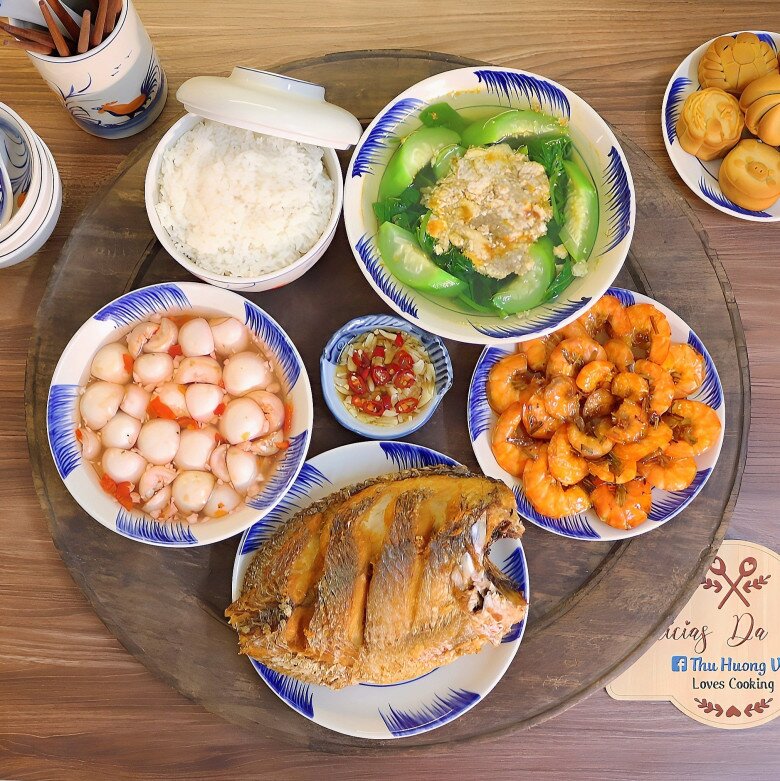 Mâm cơm này gồm các món: Cá rán, tôm rang, cà muối, canh cua mồng tơi mướp.