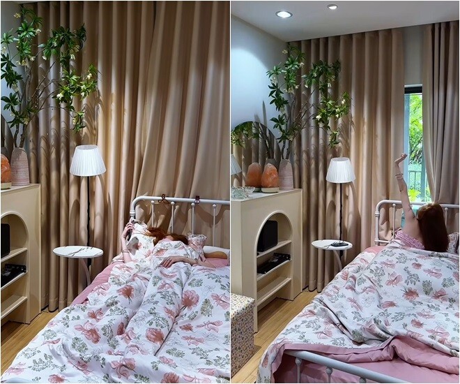 Elly Trần thức dậy trong căn phòng ngủ dịu dàng với tông màu pastel. Giường khung sắt trắng, ga trải hoa vintage, rèm màu nude tạo cảm giác ấm áp, bên cạnh là cây xanh decor cùng đèn cây trắng tối giản - không gian lý tưởng để thư giãn sau một ngày dài.