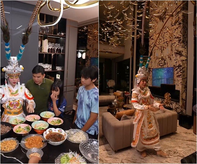 Không gian bếp sang trọng được tận dụng để bày biện một mâm cỗ đủ món, với đầy đủ màu sắc. Khu vực phòng khách cao trần với đèn chùm pha lê lấp lánh và mảng tường ốp đá vân độc đáo, là điểm nhấn nổi bật của biệt thự. Nhìn cảnh Ngô Thùy Linh hóa thân, nhiều người chỉ lo vòi rồng trên đầu cô va vào đèn trần.