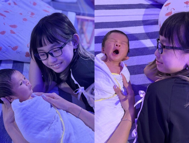 Bé Cherry âu yếm nhìn em trai - con ruột Hoa hậu Ngọc Hân.