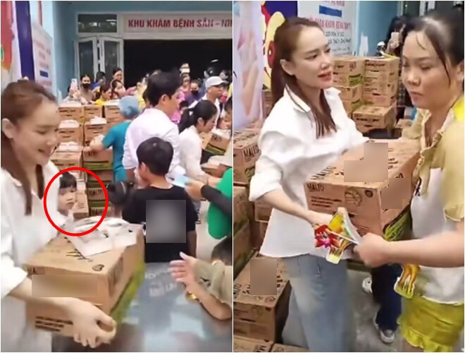 Bé Destiny ngoan ngoãn đứng bên cạnh quan sát mẹ Nhã Phương trao quà cho người dân.