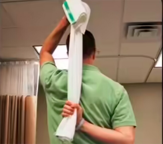 Sử dụng khăn kéo giãn cơ giúp giảm đau vai.