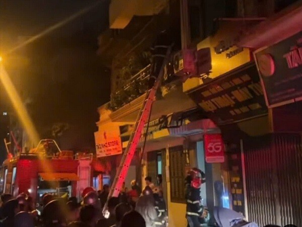 Hiện trường giải cứu người mắc kẹt trong căn nhà 4 tầng đang cháy trong đêm. Ảnh: Đ.T.