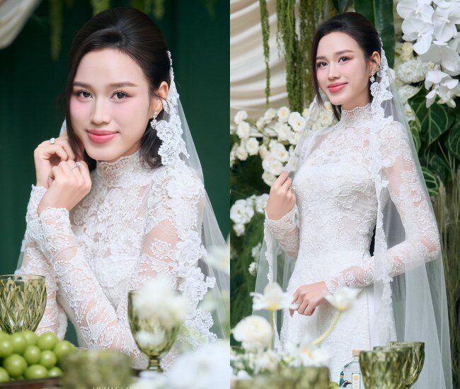Trong lễ cưới, Đỗ Thị Hà chọn áo dài ren Pháp cao cấp, cổ cao thanh lịch, tông trắng kem nhẹ nhàng. Thiết kế tôn đường nét kiêu sa, vừa kín đáo vừa quyến rũ. Hình ảnh nàng hậu trong chiếc váy cưới như minh chứng cho nhan sắc, khí chất và hạnh phúc viên mãn.