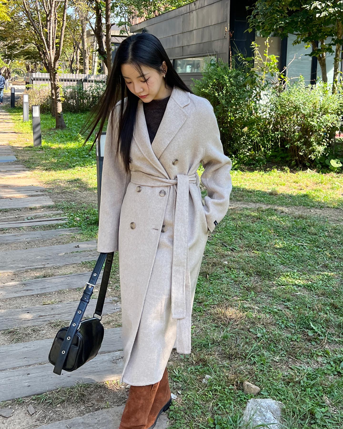 Áo khoác dài có chi tiết thắt eo hoặc chiết nhẹ sẽ giúp giữ tỷ lệ cơ thể cân đối, tránh cảm giác thẳng đuột. Kiểu áo này tôn vòng hai, tạo hiệu ứng “eo nhỏ – chân dài”. Nếu áo không có sẵn đai, thêm thắt lưng mảnh cũng giúp outfit sang hơn.